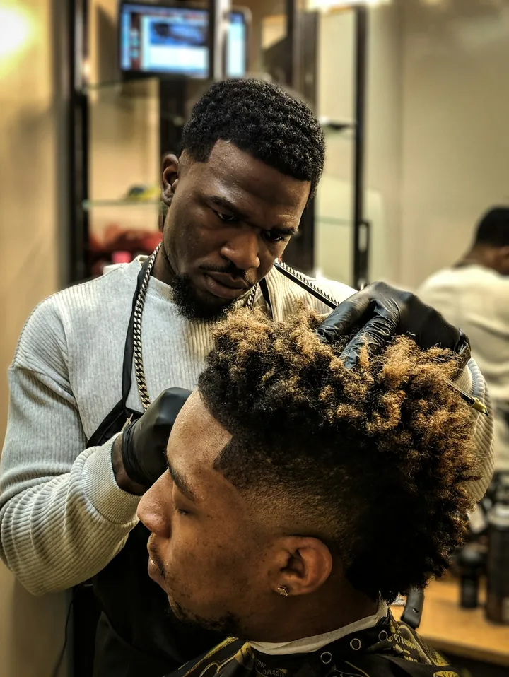 Barber shaping up a client's fade